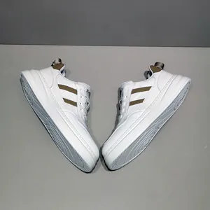 Classic white leather sneakers for men with brown stripe detail and thick outsole