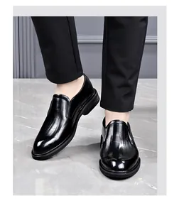 Close-up detail of men's black embossed leather formal slip-on dress shoes being worn
