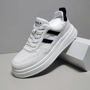 Detail view of white leather sneaker with black stripes and thick platform sole.