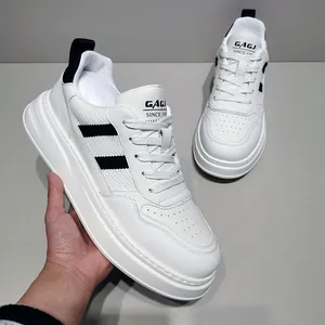 Detail shot of white leather chunky sneakers with black stripes and thick sole