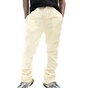 Detail view of men's cream slim-fit micro-flare drawstring casual stacked sweatpants