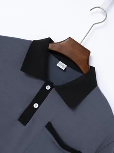 Close-up of men's grey and black contrast polo shirt collar and fabric size tag detail