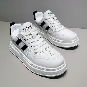 Detailed view of white leather platform sneakers with black side stripes