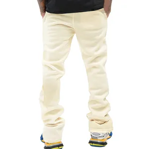 Back view of men's slim fit cream flare pants featuring heavy fabric texture details
