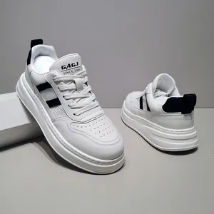 Close-up of men's white leather platform sneakers featuring stylish black side stripes
