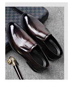 Detailed view of dark brown embossed leather men's dress shoes in a luxury setting