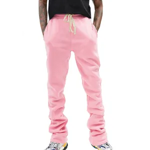 Close-up view of men's pink flared drawstring sweatpants featuring a vintage aesthetic look