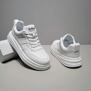 Detail of white leather platform sneakers with diagonal stripes and perforated toe box