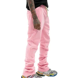 Close-up of pink stacked sweatpants for men with drawstring waist and flared hem.