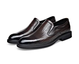 Detailed view of hollow breathable pattern on men's formal brown slip-on shoes