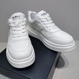 Detailed view of white leather men's sneakers with thick sole and GAGJ logo