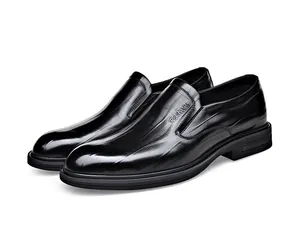 Detail shot of black formal business slip-on leather shoes with embossed pattern