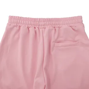 Macro view of pink flared casual pants featuring elastic waistband and back pocket detail.