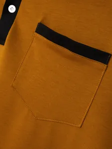 Close-up of men's polo shirt featuring a black trim chest pocket and white button detail.