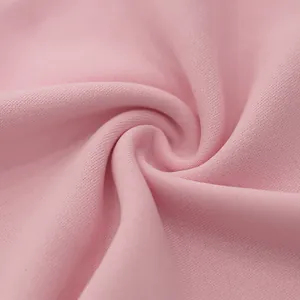 Macro detail shot showing the soft texture of heavy pink knit fabric for men's casual pants