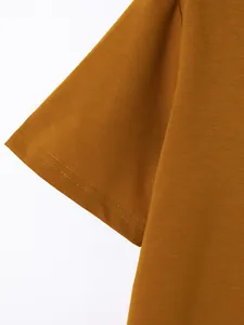 Macro detail view of the sleeve hem stitching on a mustard yellow cotton Polo shirt