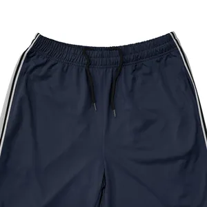 Gedetailleerd beeld van de donkerblauwe sportbroek met elastische taille en band.