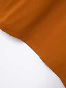 Detailed close-up showing the double-stitched hem and fabric texture of an amber Polo shirt.