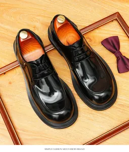 Macro view of black genuine leather round-toe Derby shoes on a classic wood base
