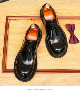 Top view of polished black men's Derby shoes on wooden floor with a stylish bow tie