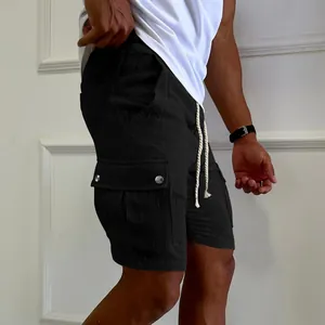 Close-up detail of men's black summer cargo shorts featuring drawstring waist and side pockets