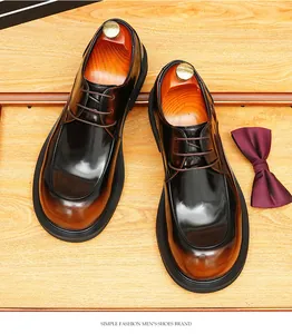 Elegant men's brown gradient leather Derby shoes with round toe on wooden surface