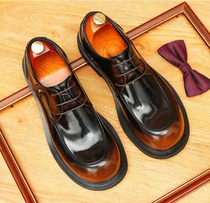 Detailed view of brown leather derby shoes with a classic round toe and warm gradient finish.