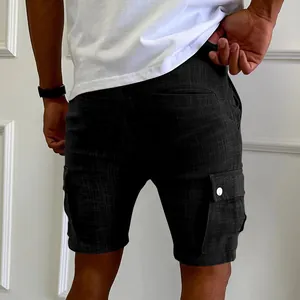 Close-up detail of men's slim black textured cargo shorts with side button pocket