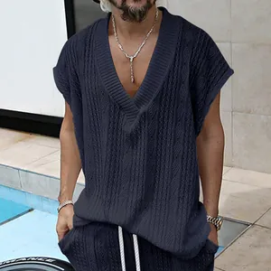 Détail de la texture de maille jacquard bleu marine et du col en V d'un gilet homme