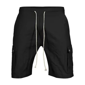 Detailed view of men's black cargo shorts featuring a cream drawstring and snap-button pockets.