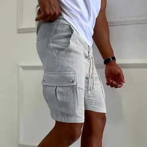 Detailed view of men's grey cargo shorts with drawstring waist and textured fabric