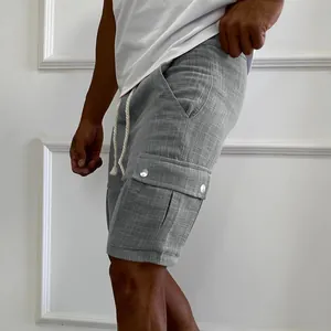 Detail showing the fabric texture and side cargo pocket of grey men's shorts.