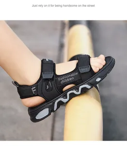 Close-up detail of black boys' lightweight sandals with 'Fashionable' printed strap