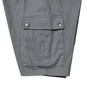 Detailed close-up view of a functional cargo pocket on grey men's slim fit shorts