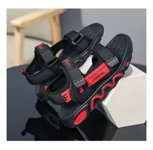 Detail of boys' black and red lightweight sport sandals with wavy patterned sole