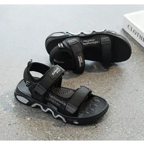 Detailed view of black children's sandals with SPORT straps and soft textured soles