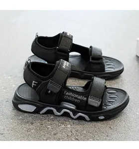 Detailed side view of black boys' lightweight sports sandals with velcro straps