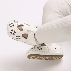 Detailweergave van witte babysandalen met hartuitsnijdingen en zachte rubberen zool