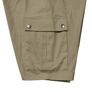 Macro view showing the durable cargo pocket and snap button details on khaki men's shorts