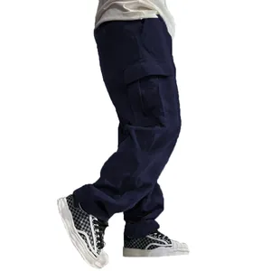 Close-up view showing the texture and fit of men's navy blue corduroy cargo pants.