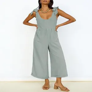 Full-body view of a sage green wide-leg jumpsuit with U-neck and tie-shoulder straps