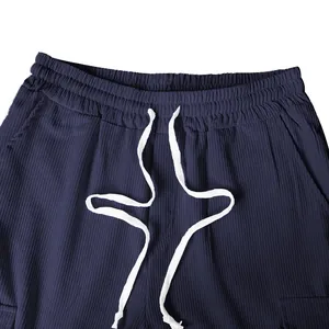 Detailed view of navy blue corduroy casual trousers featuring elastic drawstring waistband