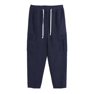 Detailed view of navy blue corduroy cargo pants with a drawstring waistline