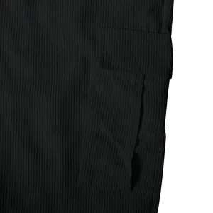 Detailed close-up showing the ribbed black corduroy fabric and functional cargo pocket