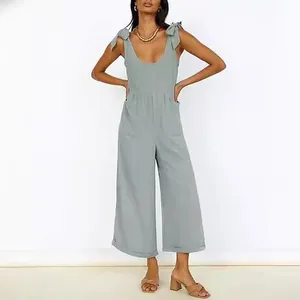Elegant solid color wide leg jumpsuit with adjustable tie straps and a deep U-neck design