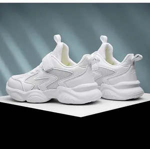 Side detail view of breathable white children's sneakers with comfortable Velcro strap.
