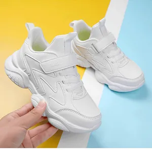 Close-up of lightweight white children's sneakers with velcro and lace-up closure