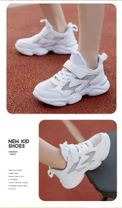 Detailed view of breathable white kids sneakers with mesh texture and velcro strap
