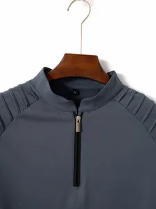 Detail view of men's grey long-sleeve polo shirt with zipper and pleated shoulders