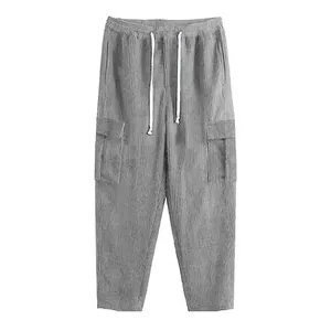 Detail of grey corduroy cargo pants showing texture and side pockets